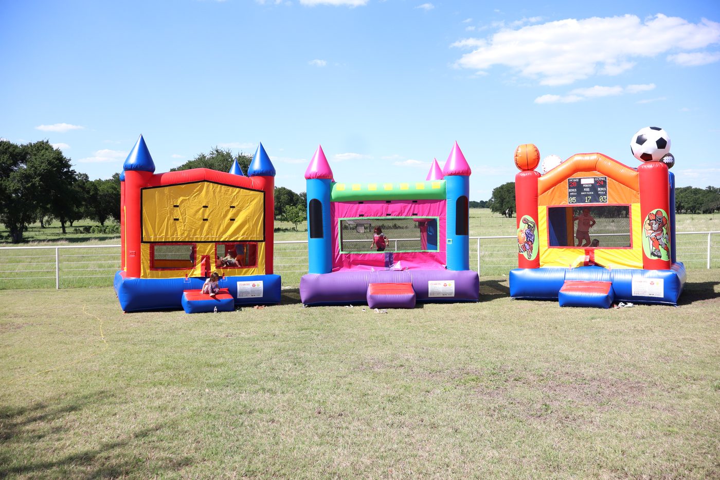 Texoma Bounce fleet of bounce houses set up outdoors in North Texas with kids playing